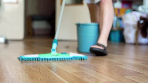 Cleaning the floor with a mop closeup. Hosehold and clean home concept. Stock Footage 301976499