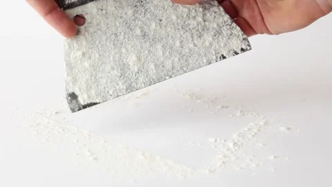Cleaning flour from bread dough scraper by hand fast motion Stock Footage 196000251