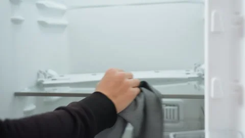 Cleaning fridge shelves. Sanitizing fridge interior with microfiber cloth Stock Footage 337456543