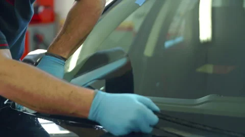 Cleaning the front window of a car after the problem has been taken care of Stock Footage 59921000