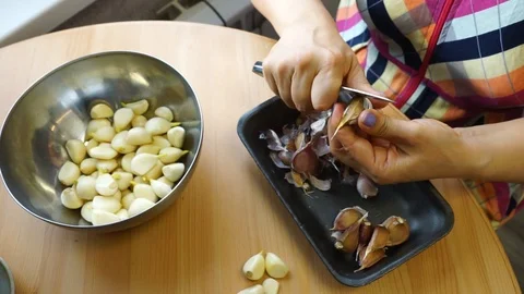 Cleaning garlic with a knife. Stock Footage 106066662