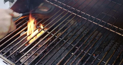Cleaning gas grill with wire brush, flaming, smokey  - audio Stock Footage 137928341