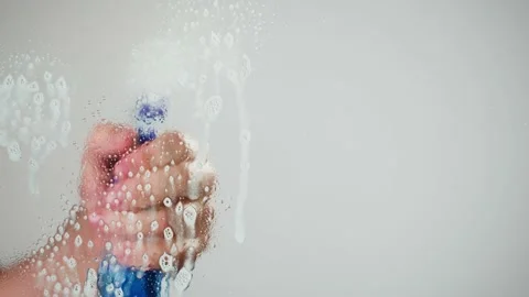 Cleaning glass, using spray detergent on grey chroma key background. Spring Видео 182003819