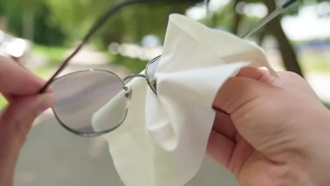 Cleaning glasses with white cloth. Macro of a person with a white microfibe.. Stock-Footage 339528711