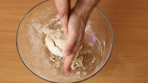 Cleaning hand from excess of dough. Making Puff Pastry Series. Stock Footage 77222376