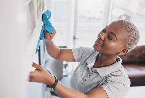 Cleaning, happy and dust with black woman in living rom for housekeeping Stock Photos