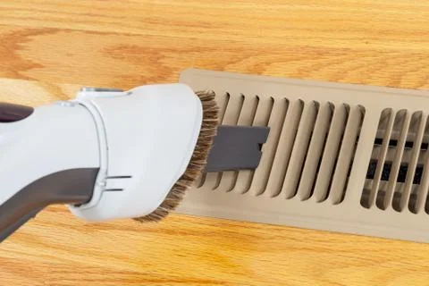 Cleaning heater vent withvacuum Stock Photos