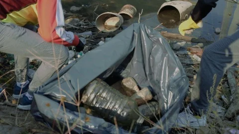 Cleaning the highly polluted river with plastic waste. Stock Footage 121906946