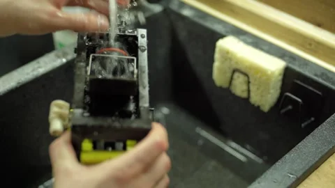 Cleaning the home automatic coffee maker, rinsing the brewing unit. Stock Footage 306612122
