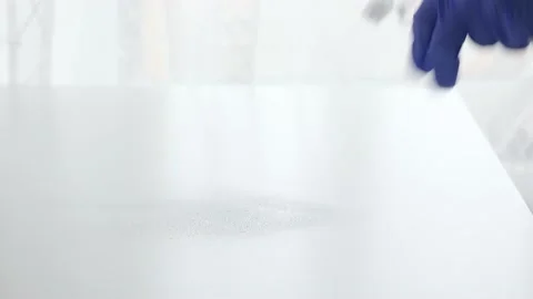 Cleaning home table sanitizing workplace table surface with disinfectant spray Stock Footage 147375845