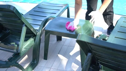 Cleaning in hotel pool and sunbed. Stock Footage 136860844