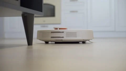 Cleaning the house with a robot vacuum cleaner Stock Footage 219997797