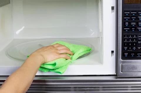 Cleaning inside of microwave oven Stock Photos