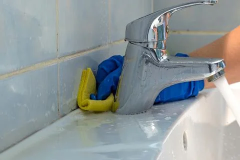 Cleaning of inter tile joints in bathroom from dirt Stock Photos