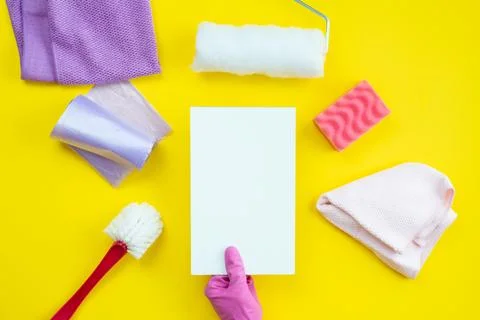 Cleaning items and a clean layout lie on a yellow background. Cleaning serv.. Stock Photos