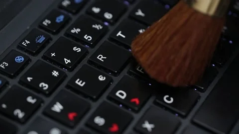 Cleaning the keyboard with a soft brush Stock Footage 211638991
