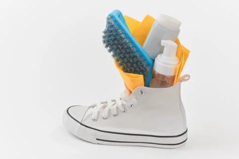 Cleaning kit inside of a canvas sneaker on white background Stock Photos
