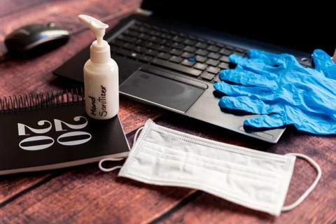 Cleaning kit for remote work home office desk with hand sanitizer and face ma Stock Photos
