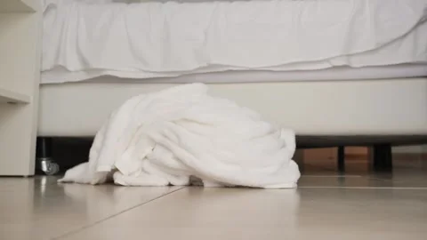 A cleaning lady throws used towels on the floor of a hotel room. Room cleaning Stock Footage 332592419