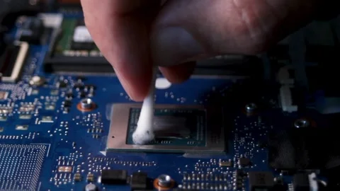 Cleaning the laptop processor from old thermal paste. Close-up of the thermal Stock Footage 316088040