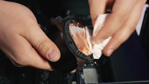 Cleaning liquid cooling block from residual thermal paste Stock Footage 328984014