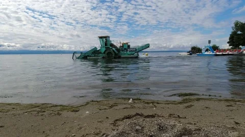 Cleaning machine boat removing pollution and algae from lake water in Geneva Stock Footage 159280419