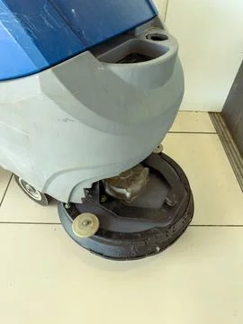 Cleaning machine used on tile floor in a commercial space during daytime Stock Photos