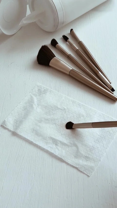 Cleaning makeup brushes with special disinfecting cloth. Wiping the tool Stock Footage 288116694