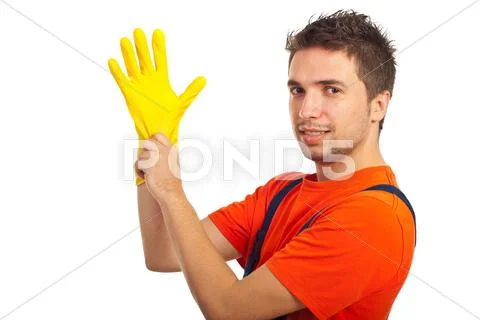 Cleaning man putting latex glove Stock Photos