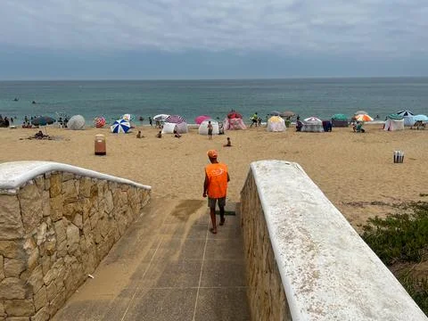 Cleaning man sweeping the pathway to the beach Stock Photos
