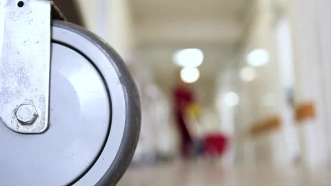 Cleaning Manager or nurse walking down hospital corridor with cleaning supplies Stock Footage 149572432