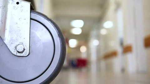 Cleaning Manager or nurse walking down hospital corridor with cleaning supplies Stock Footage 149572455
