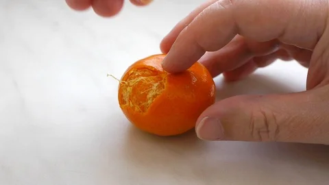 Cleaning mandarin on marble background. Stock Footage 111808569