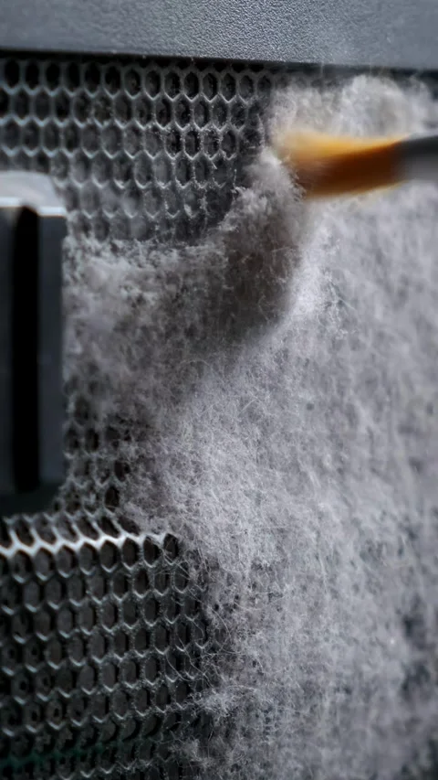 Cleaning the metal grid on the computer from dust with a close-up brush. A .. Stock Footage 291952050