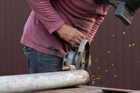 Cleaning metal structures with an angle grinder, dangerous work for our eyes Stock Photos