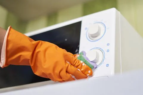 Cleaning microwave in the kitchen Stock Photos