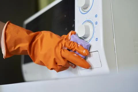 Cleaning microwave in the kitchen Stock Photos