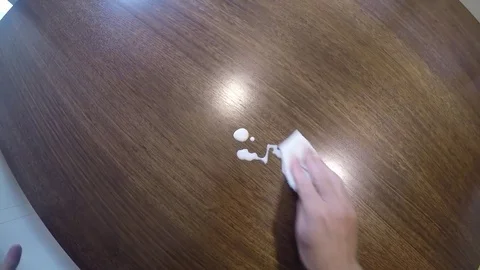 Cleaning milk up off the dining table Stock Footage 77413495