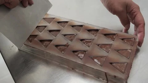 Cleaning molds using a pastry spatula. Stock Footage 132800236