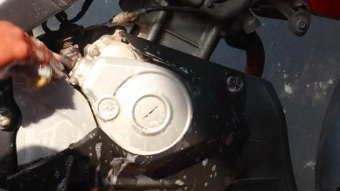 Cleaning a motorcycle engine and body with a soapy sponge Stock Footage 345549359