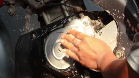 Cleaning a motorcycle engine and body with a soapy sponge Stock Footage 345549365