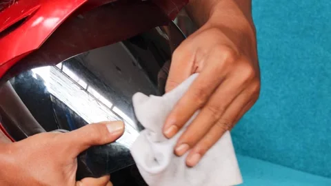 Cleaning a motorcycle helmet visor Stock Footage 340265118