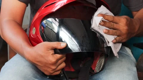Cleaning a motorcycle helmet visor Stock Footage 340265144