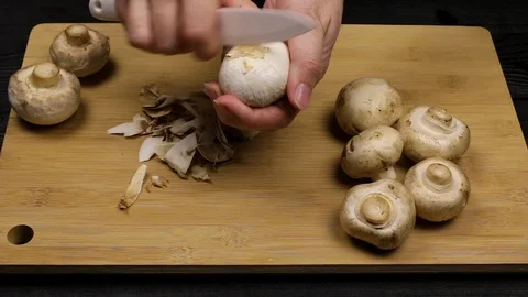 Cleaning the mushrooms as part of the cooking process according to a home-cooked Stock Footage 107508289