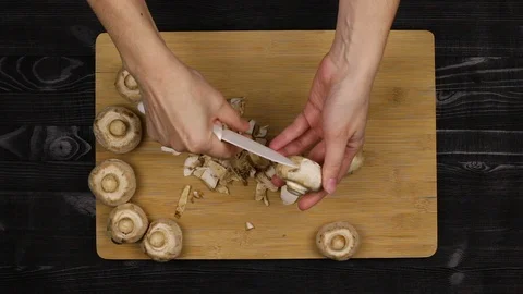Cleaning the mushrooms as part of the cooking process according to a home-cooked Stock Footage 107508664
