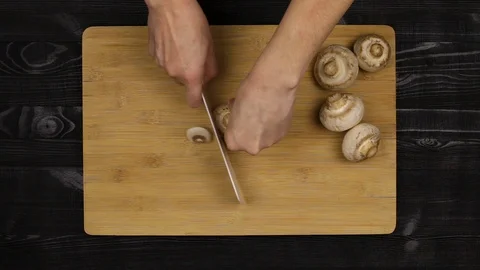 Cleaning the mushrooms as part of the cooking process according to a home-cooked Stock Footage 107509072
