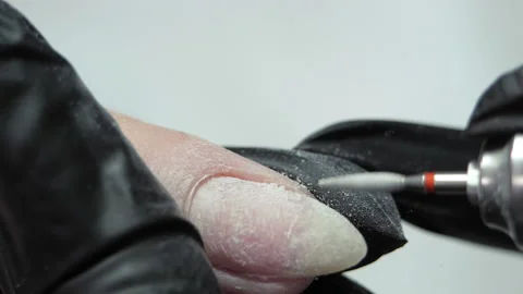 Cleaning the nail of the hand with a milling machine. Hardware combined manicure Stock Footage 211479182