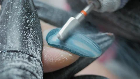 Cleaning the nail of the hand with a milling machine. Hardware combined manicure Stock Footage 254914429