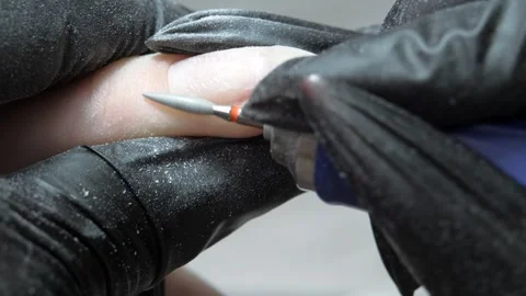 Cleaning the nail of the hand with a milling machine. Hardware combined manicure Stock Footage 287946249