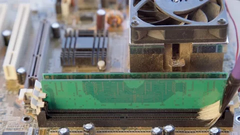 Cleaning an old computer motherboard from dust and dirt with a brush. Close-up. Stock Footage 209299731
